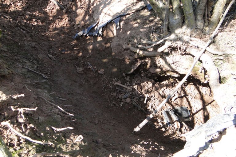 a freshly dug fox hole