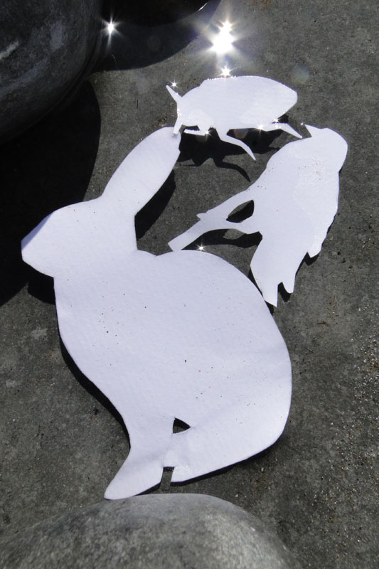 paper cut outs of beetle , bird and hare